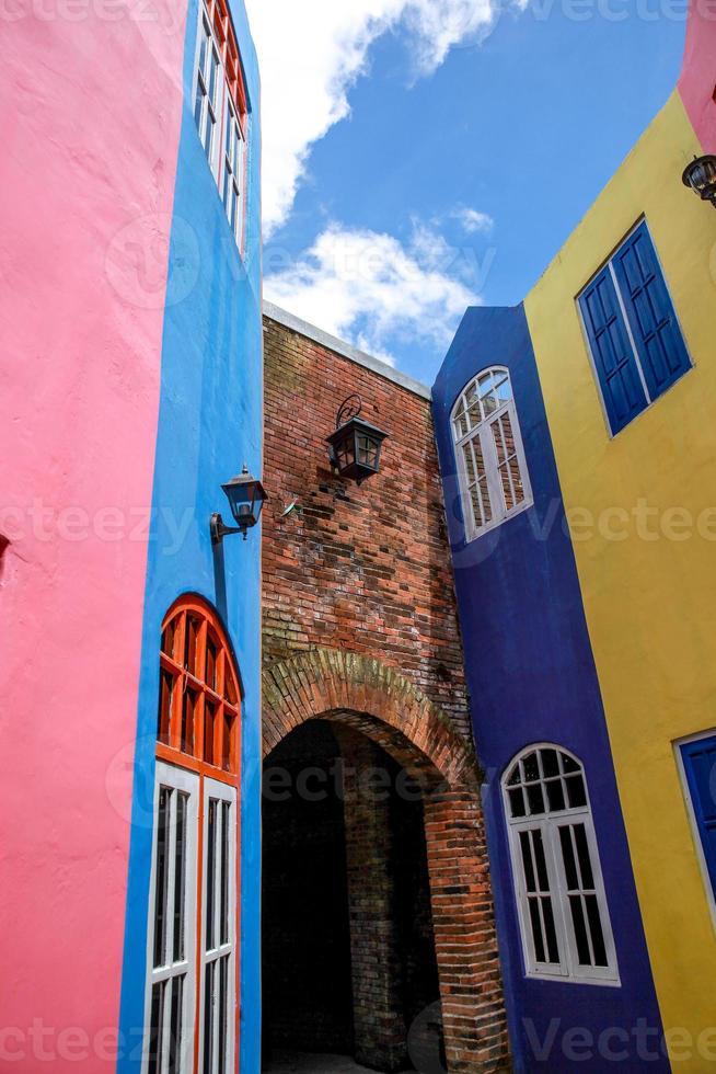 Colorful house building with brick tunnel photo
