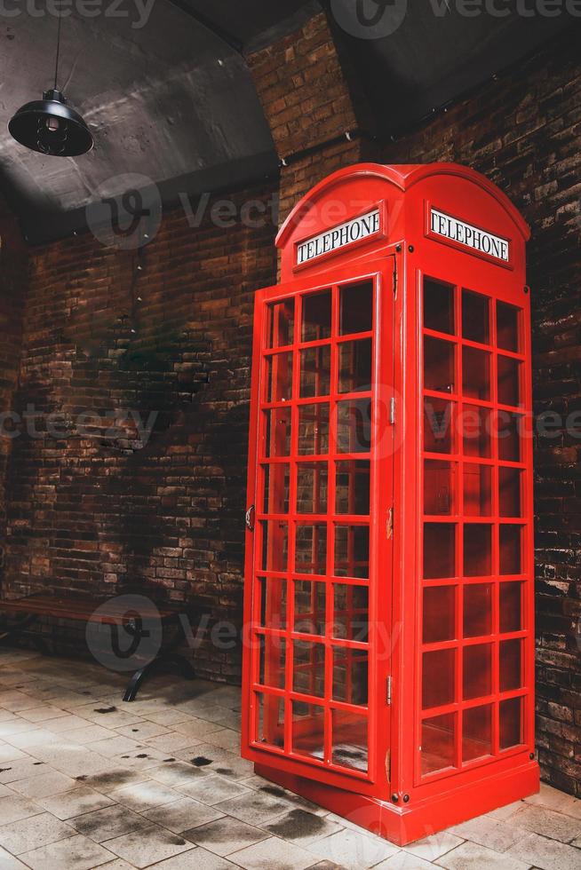 Vintage red telephone booth at public area photo