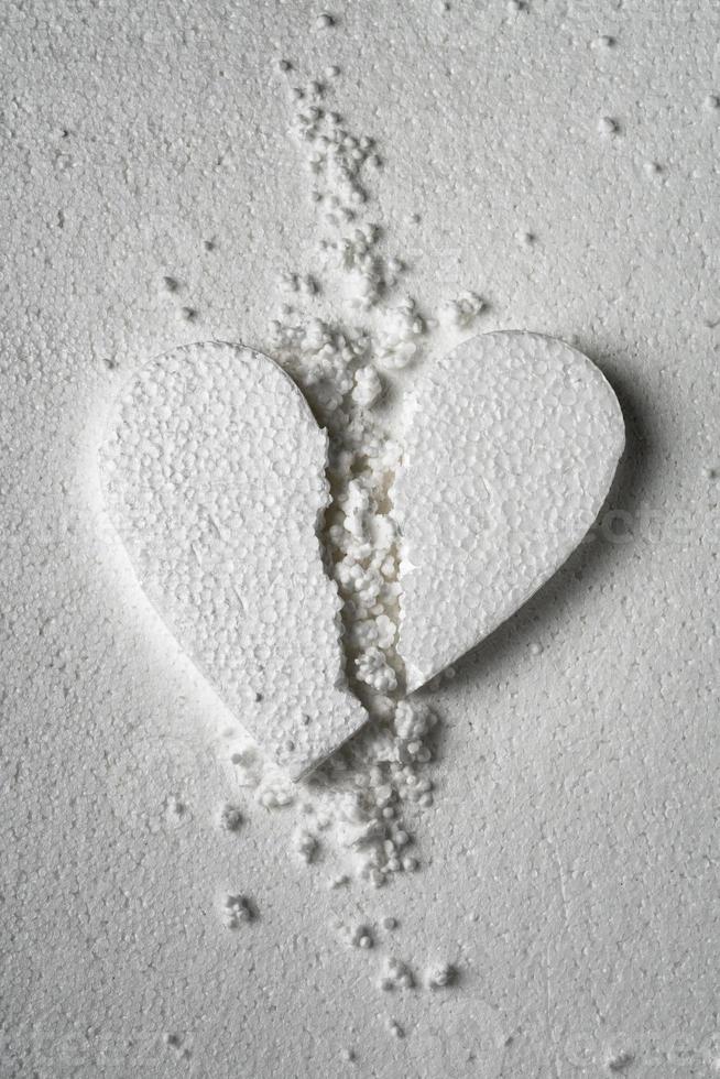 White broken styrofoam heart on a white styrofoam background close up photo