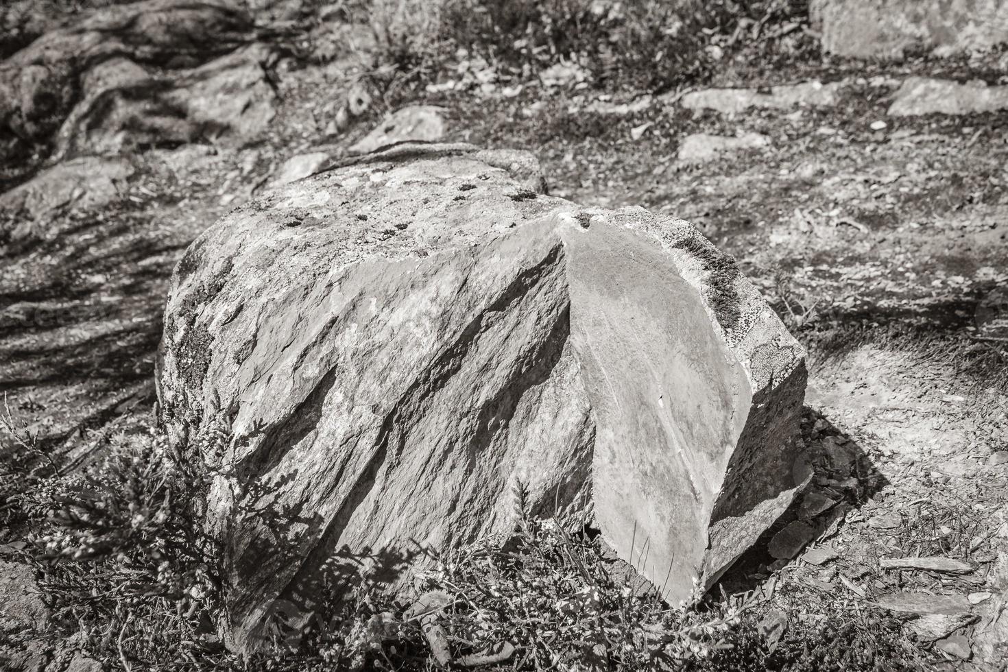 Stone rock split broken with orange yellow colors inside Norway. photo