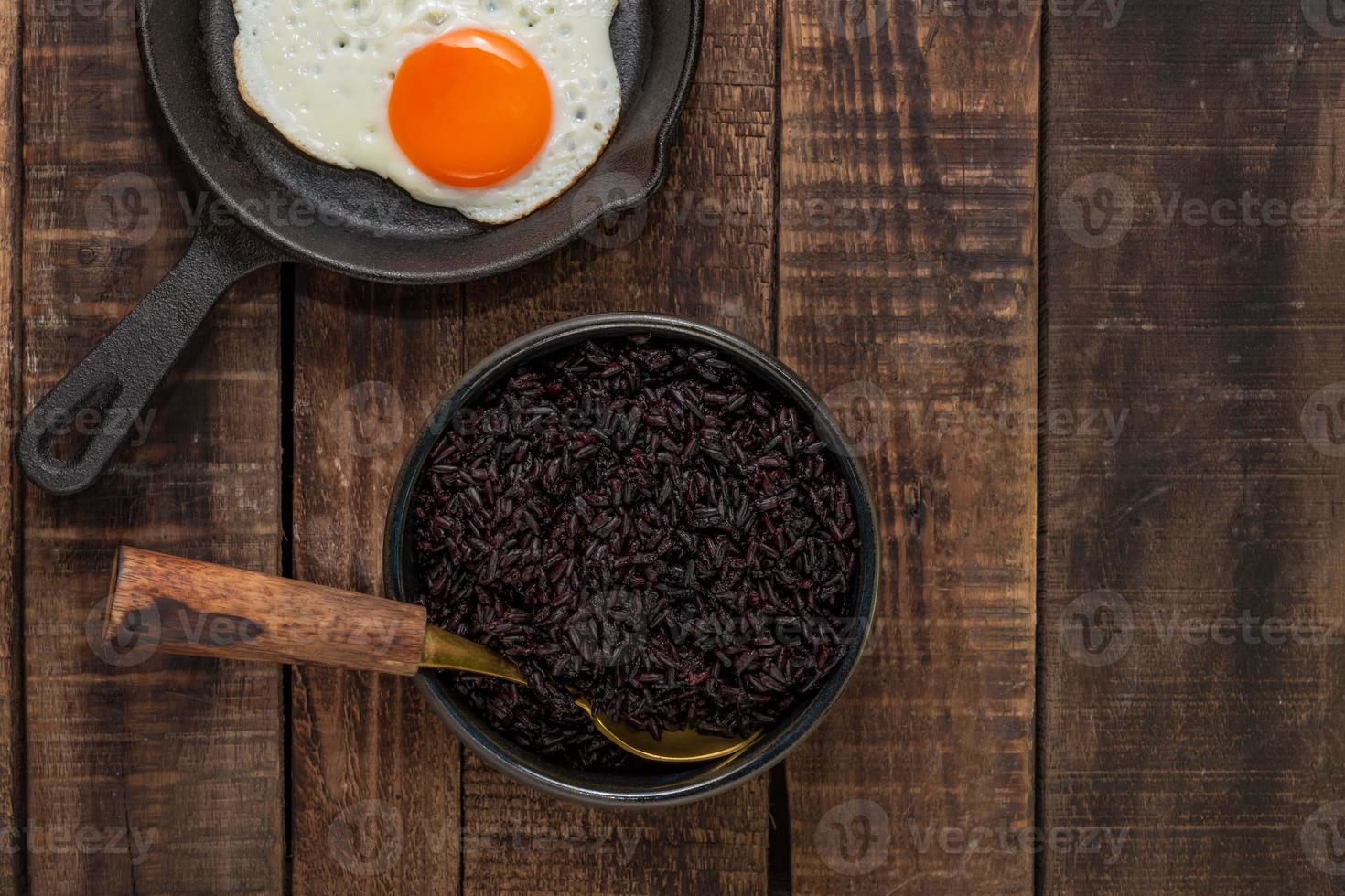 Healthy food black rice in bowl have fried egg in pan photo