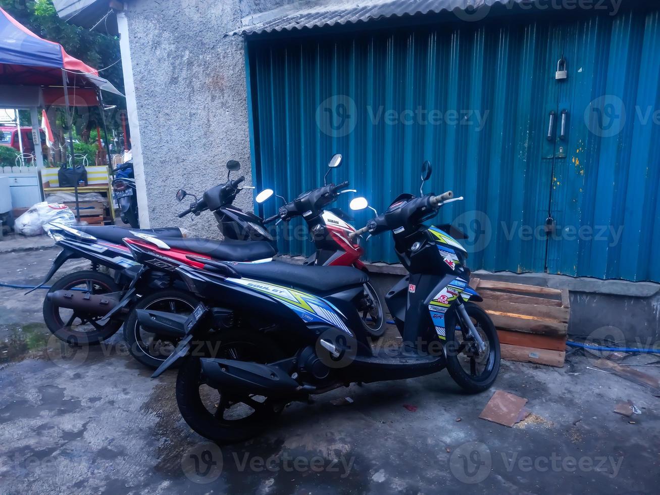 Jakarta, Indonesia 07 March 2022 - A neatly lined automatic motorbike is parked in front of a shophouse in the Jakarta area photo