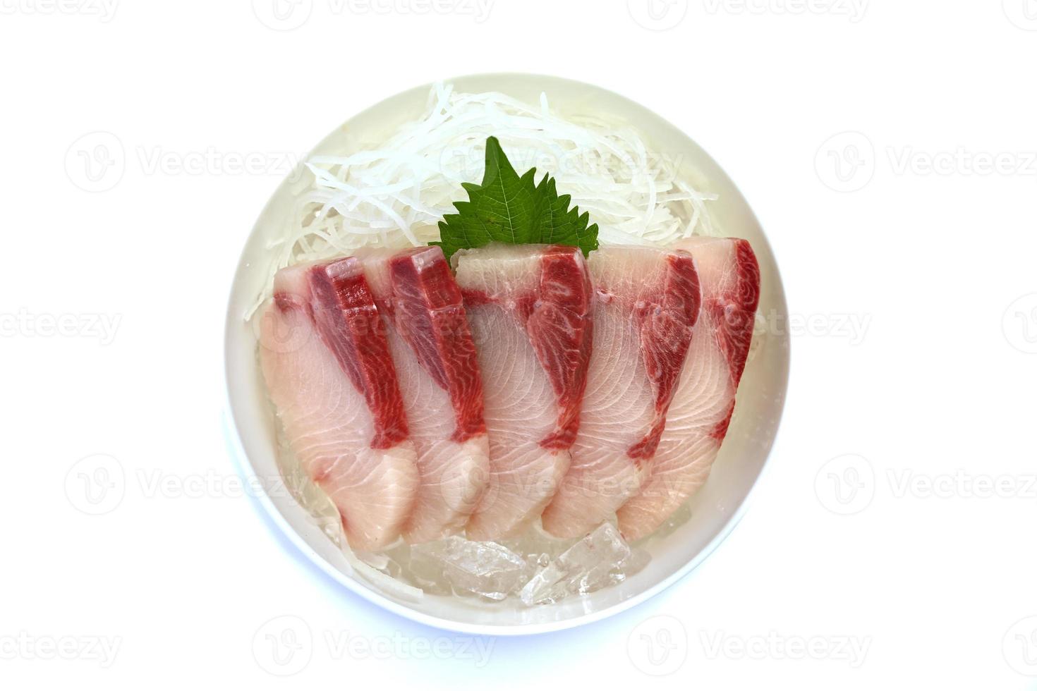 Sashimi, sliced hamachi, placed on ice in a bowl. photo