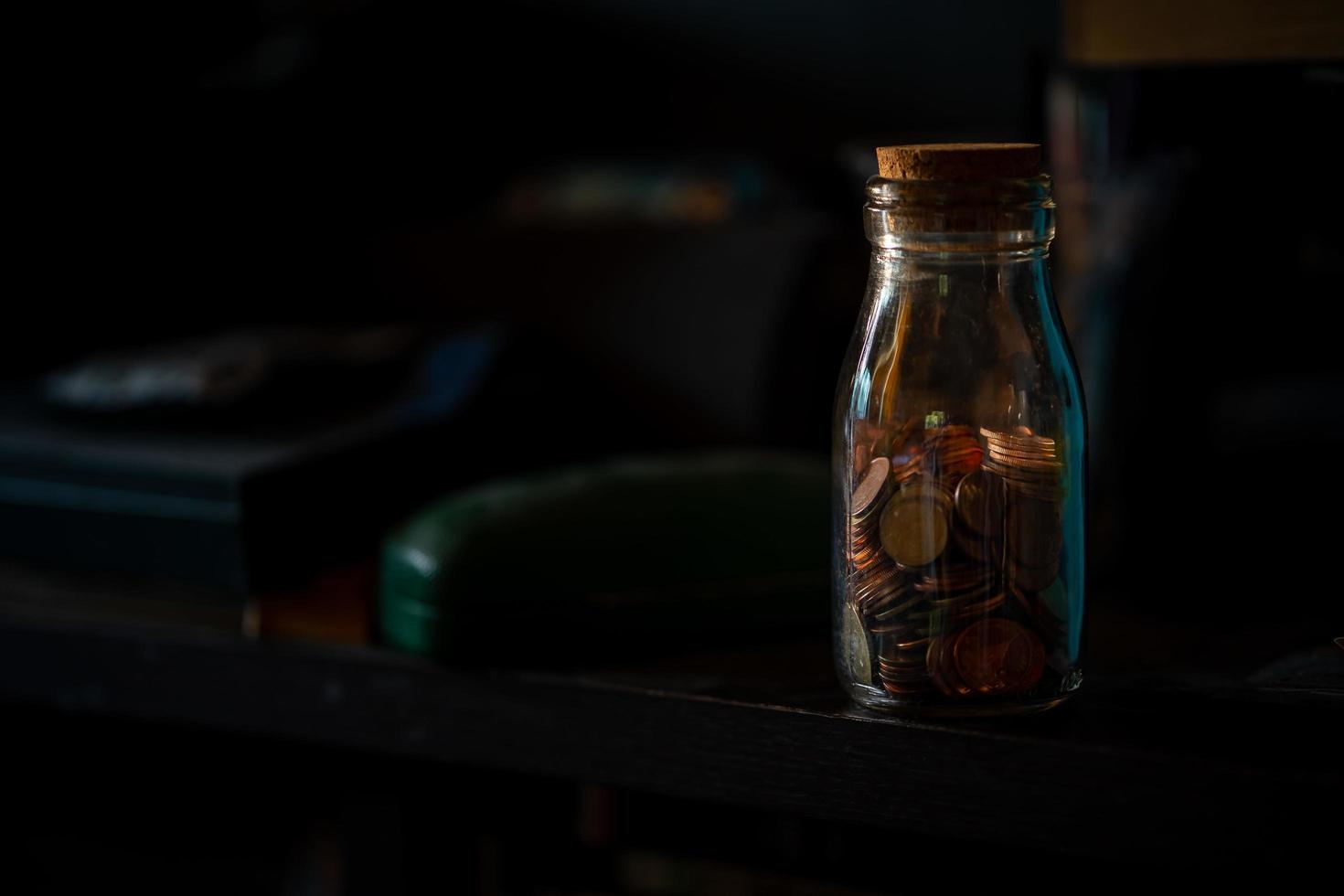 concepto de guardar monedas en tarro de cristal, foto