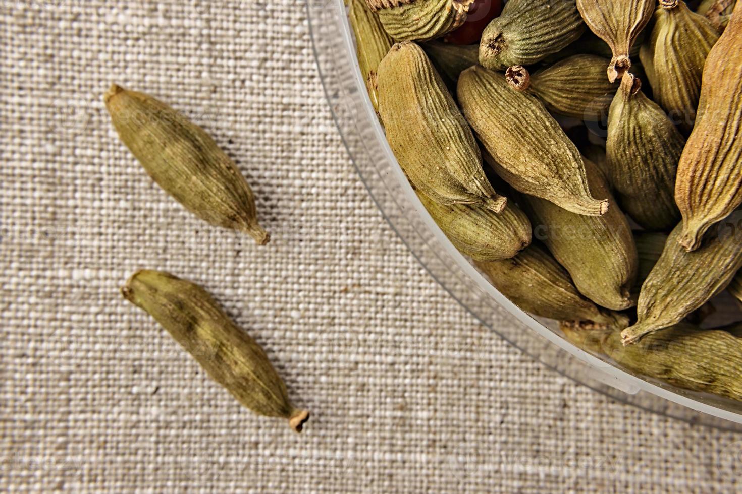 Cardamom close up on sackcloth. Ideal for flavoring Gin Tonic. photo