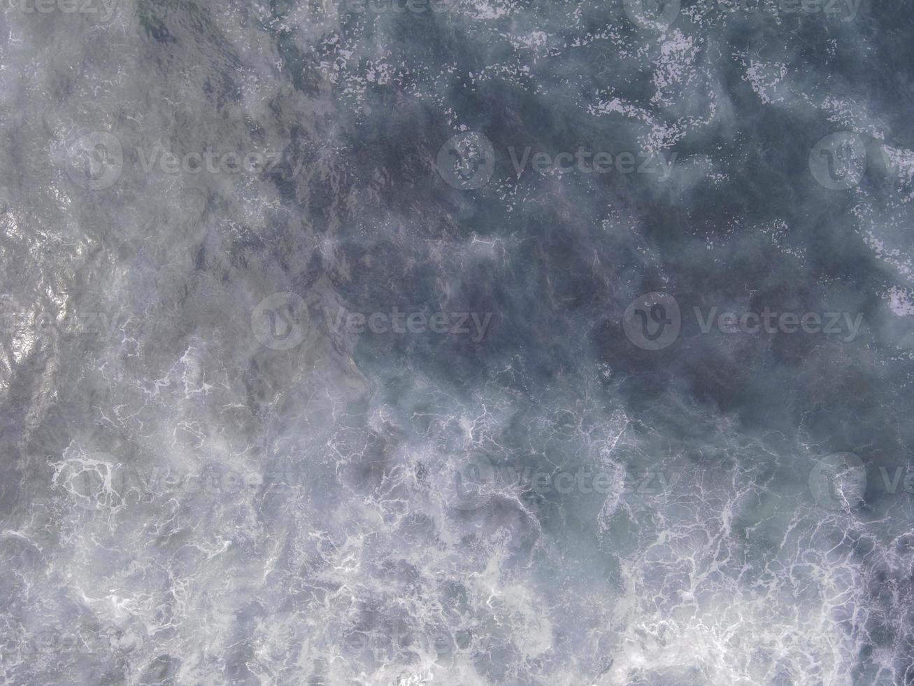 Aerial view to tropical beach and wave blue ocean at Indonesia. photo