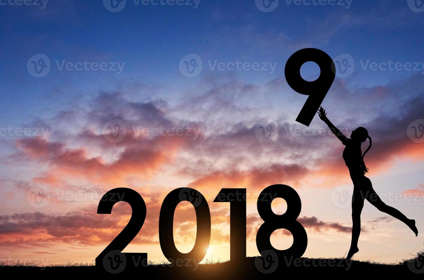 Silhouette of the girl who holds the numbers of the new year in the sunset. Concept of replacement 2018 to 2019 photo