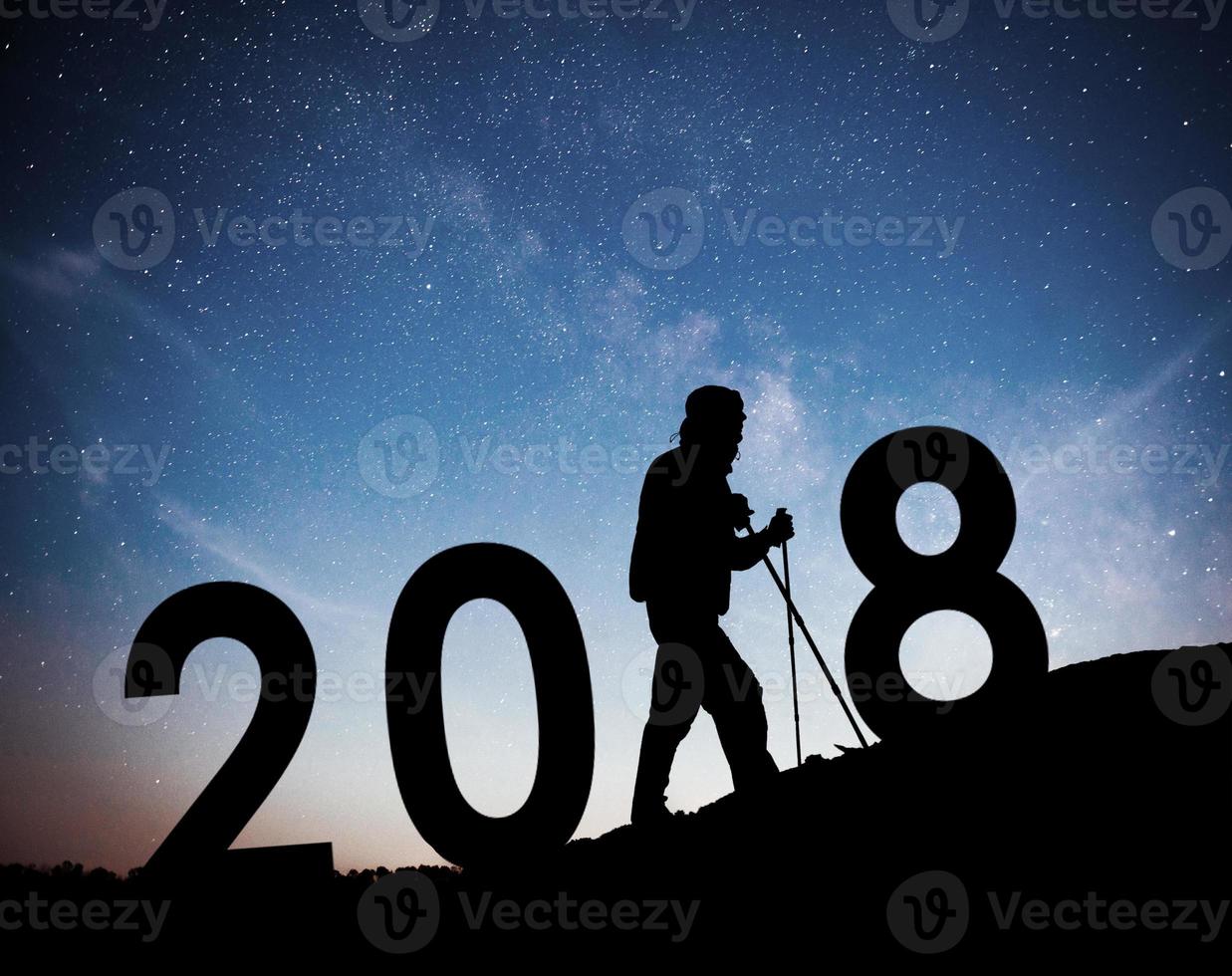 Silhouette young hiker man for 2018 new year background of the Milky Way galaxy on a bright star dark sky tone photo