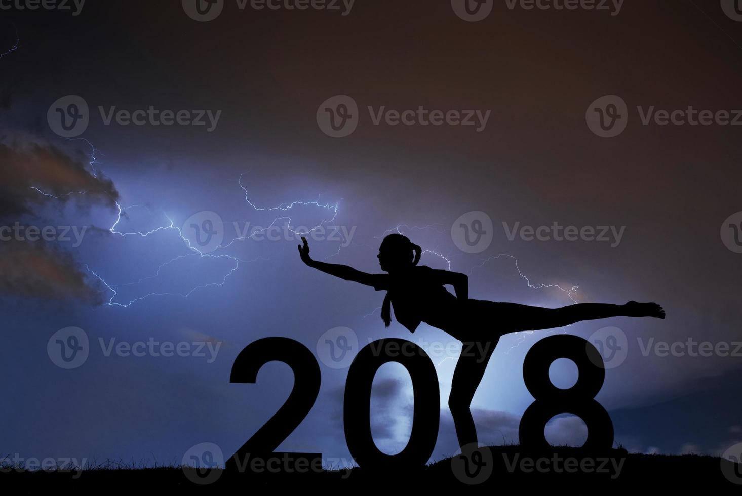 Silhouette young girl is relaxing. 2019 new year background of stormy sky. photo