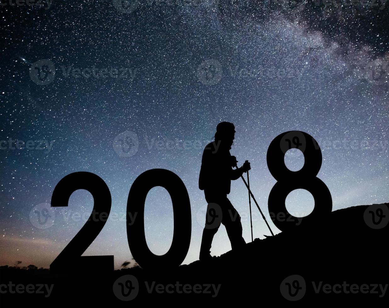 Silhouette young hiker man for 2018 new year background of the Milky Way galaxy on a bright star dark sky tone photo
