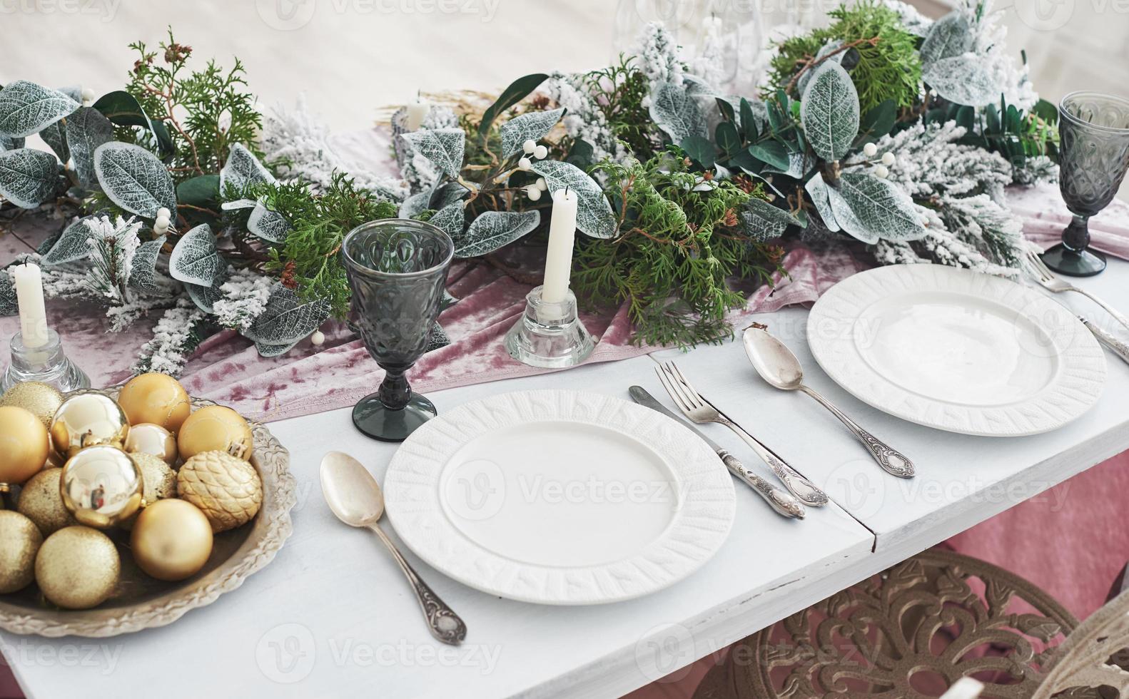 Table served for Christmas dinner in living room, top view photo