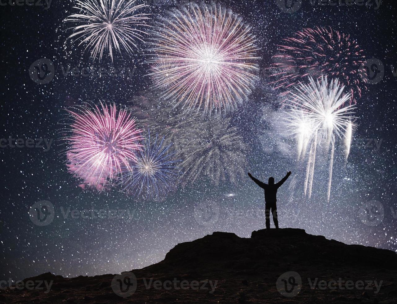 Silhouette young man background of the Milky Way galaxy on a bright star dark sky tone. Fireworks, holiday concept photo