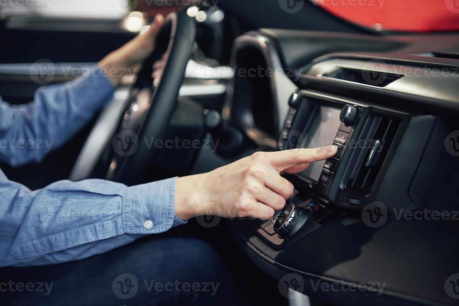 auto business, car sale, consumerism and people concept - happy woman taking car key from dealer in auto show or salon photo