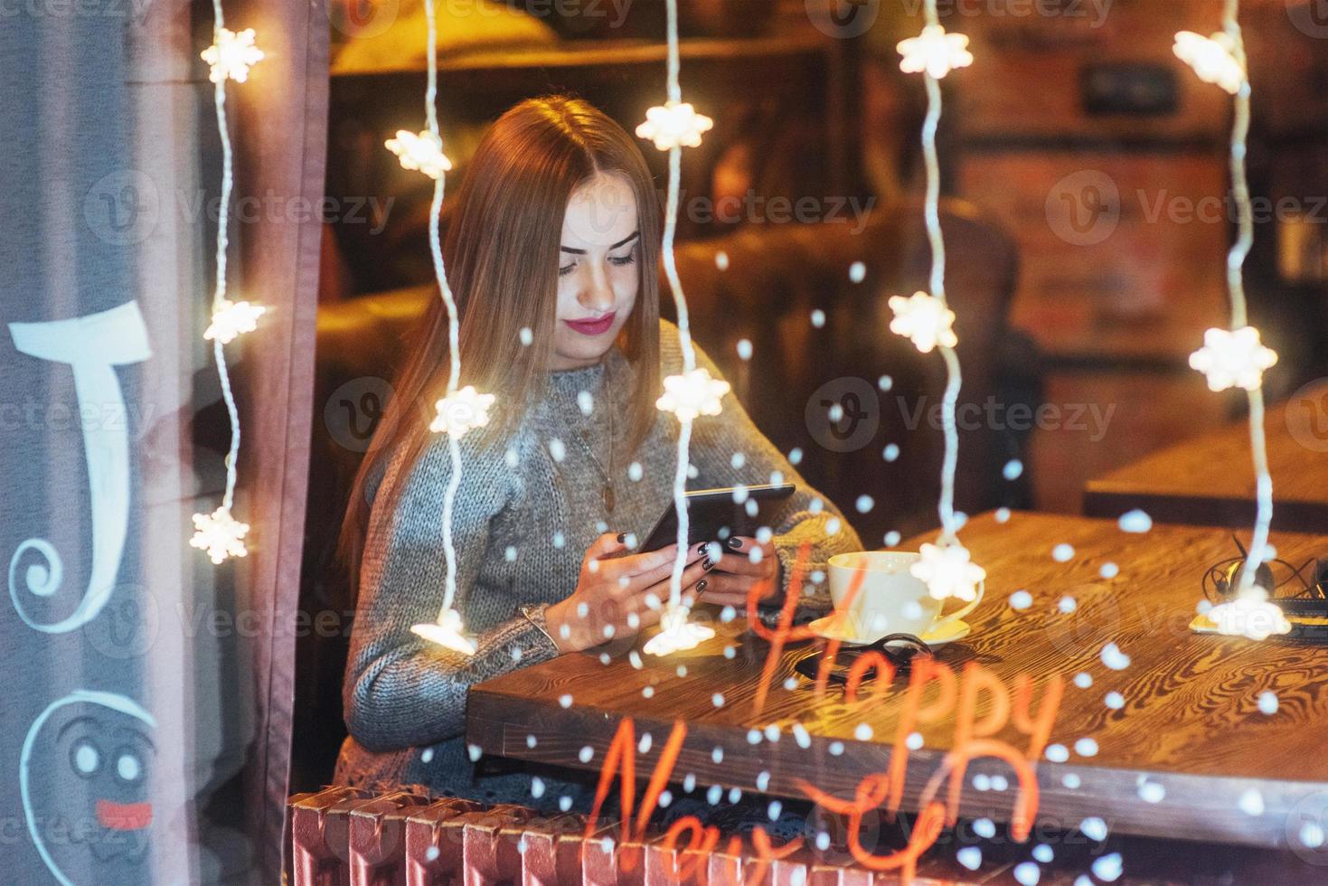 Young beautiful woman sitting in cafe, drinking coffee. Christmas, new year, Valentines day, winter holidays concept photo