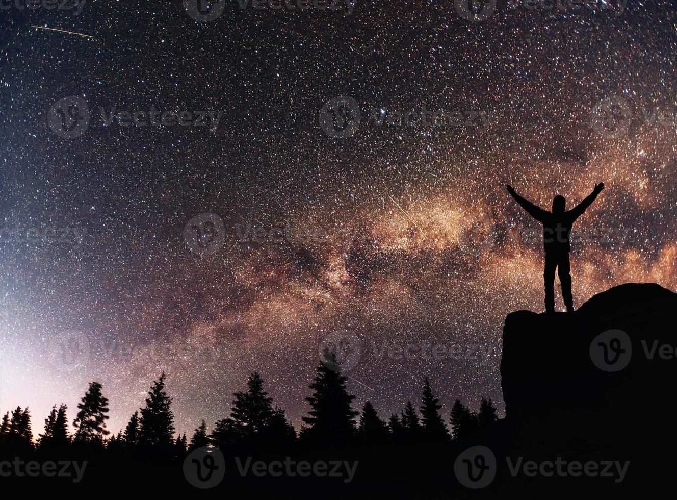 Silhouette young man background of the Milky Way galaxy on a bright star dark sky tone photo