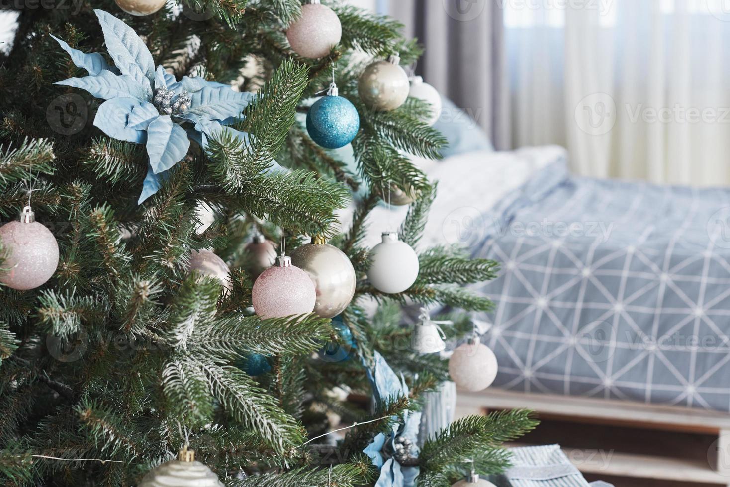 Close up of colorful ornaments on Christmas tree photo