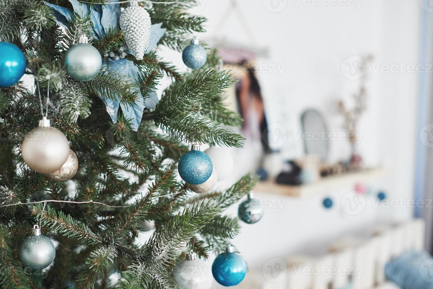 Close up of colorful ornaments on Christmas tree photo