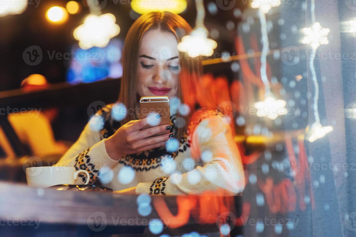 Young beautiful woman sitting in cafe, drinking coffee. Christmas, new year, Valentines day, winter holidays concept photo