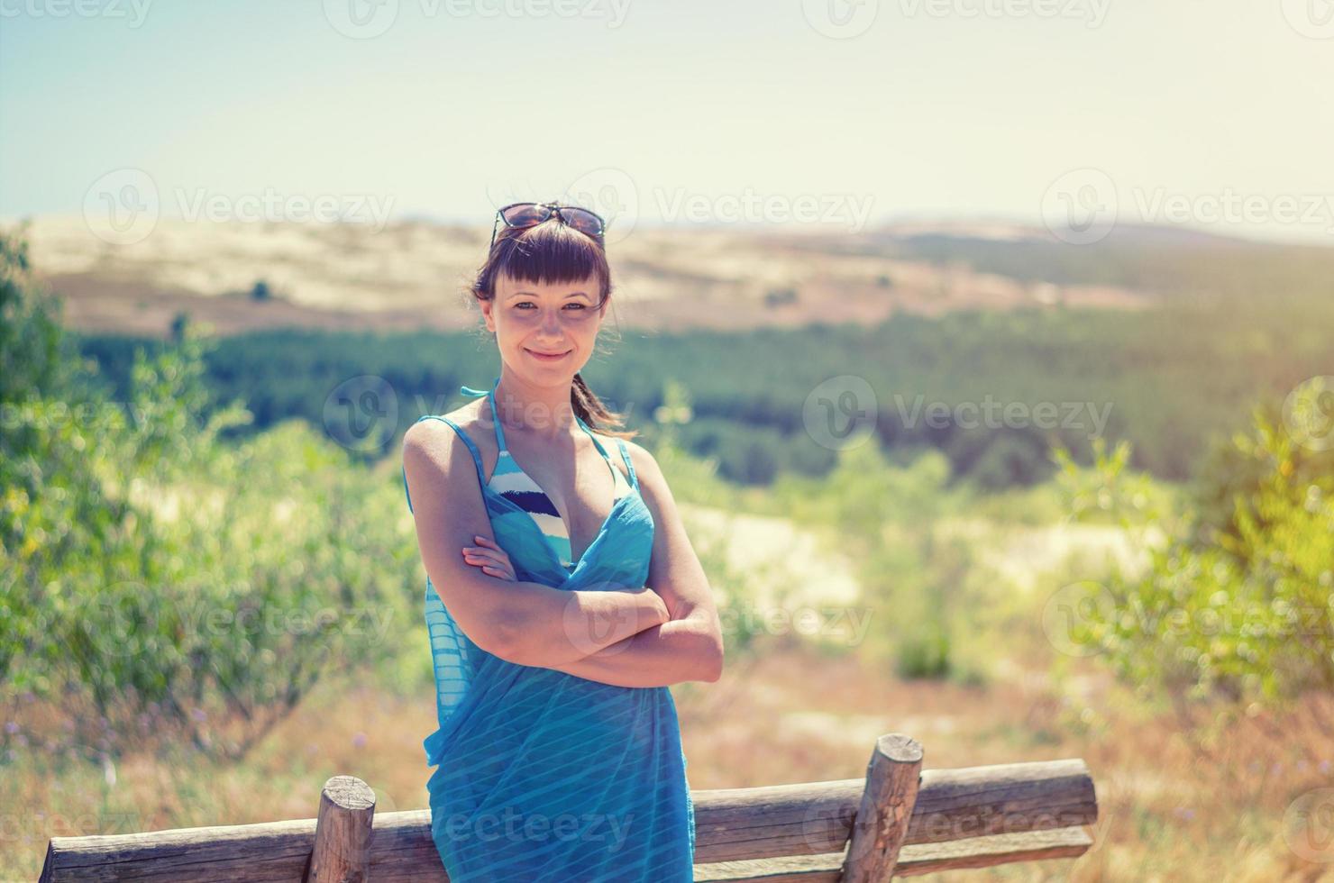 Young beautiful girl in bikini, pareo wrap and sunglasses on head posing photo