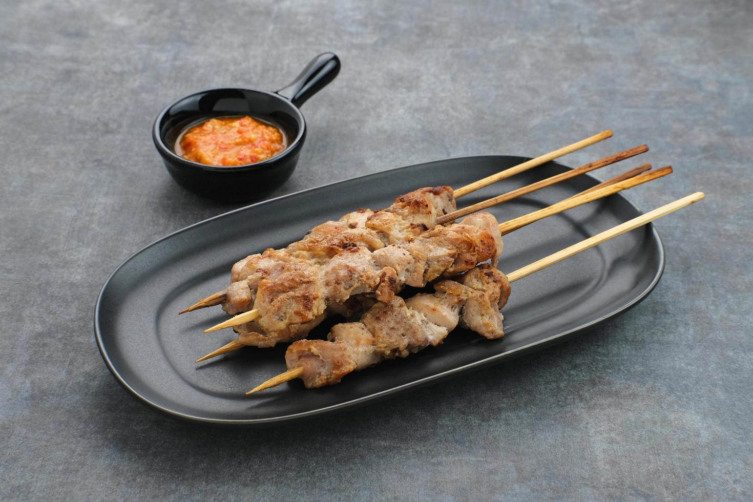 Sate Taichan, Grilled Chicken Satay without peanut sauce or soy sauce. Served on plate with chilli sauce. photo