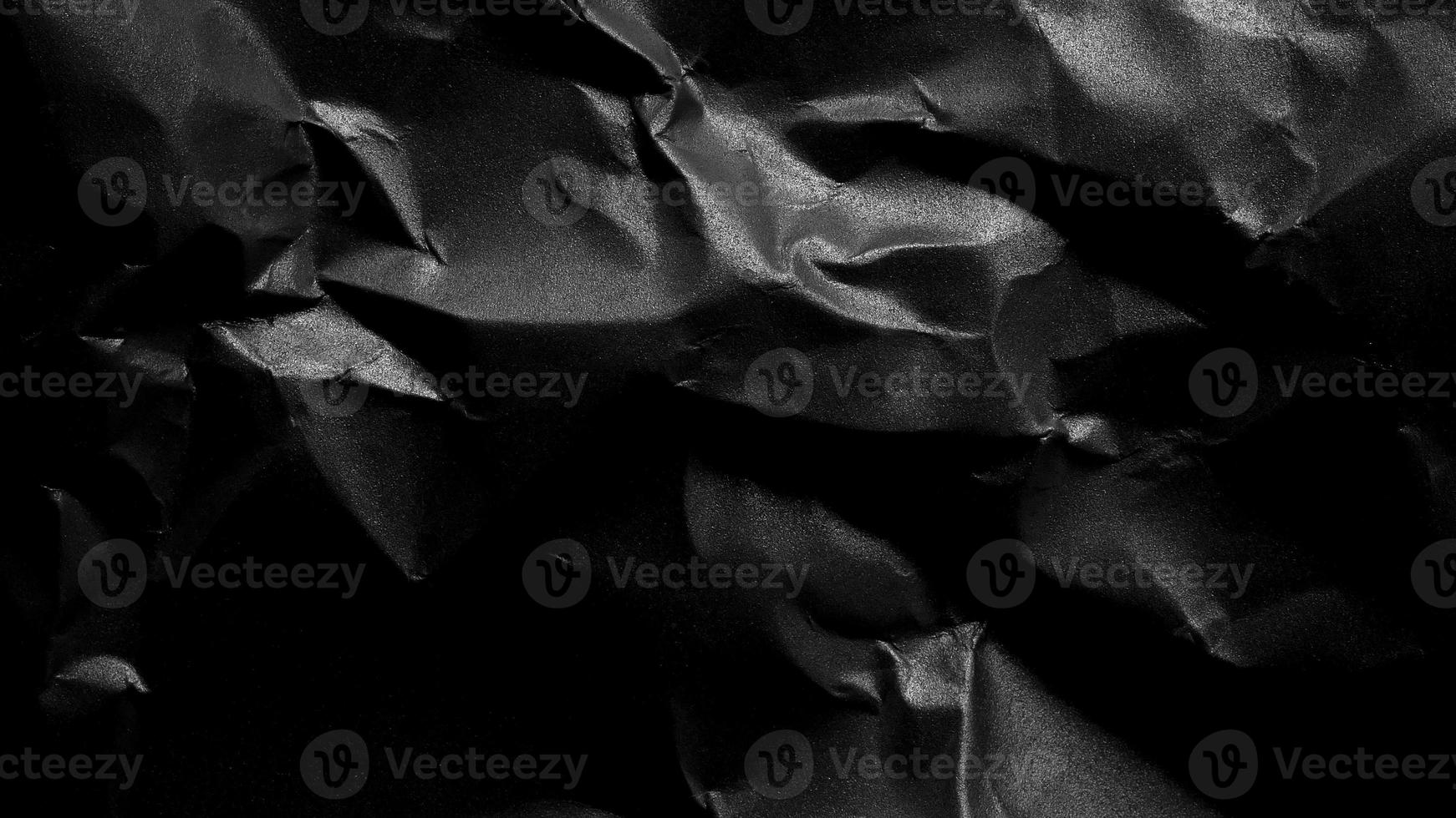 black crumpled paper texture background with copy space for text or image photo