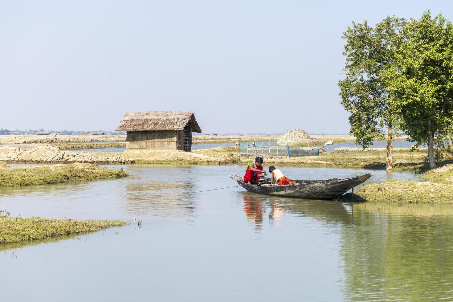 Satkhira, Bangladesh - 29 January 2017 - Mother with her young Child, on a floating boat, on the pond, fishing, countryside photo