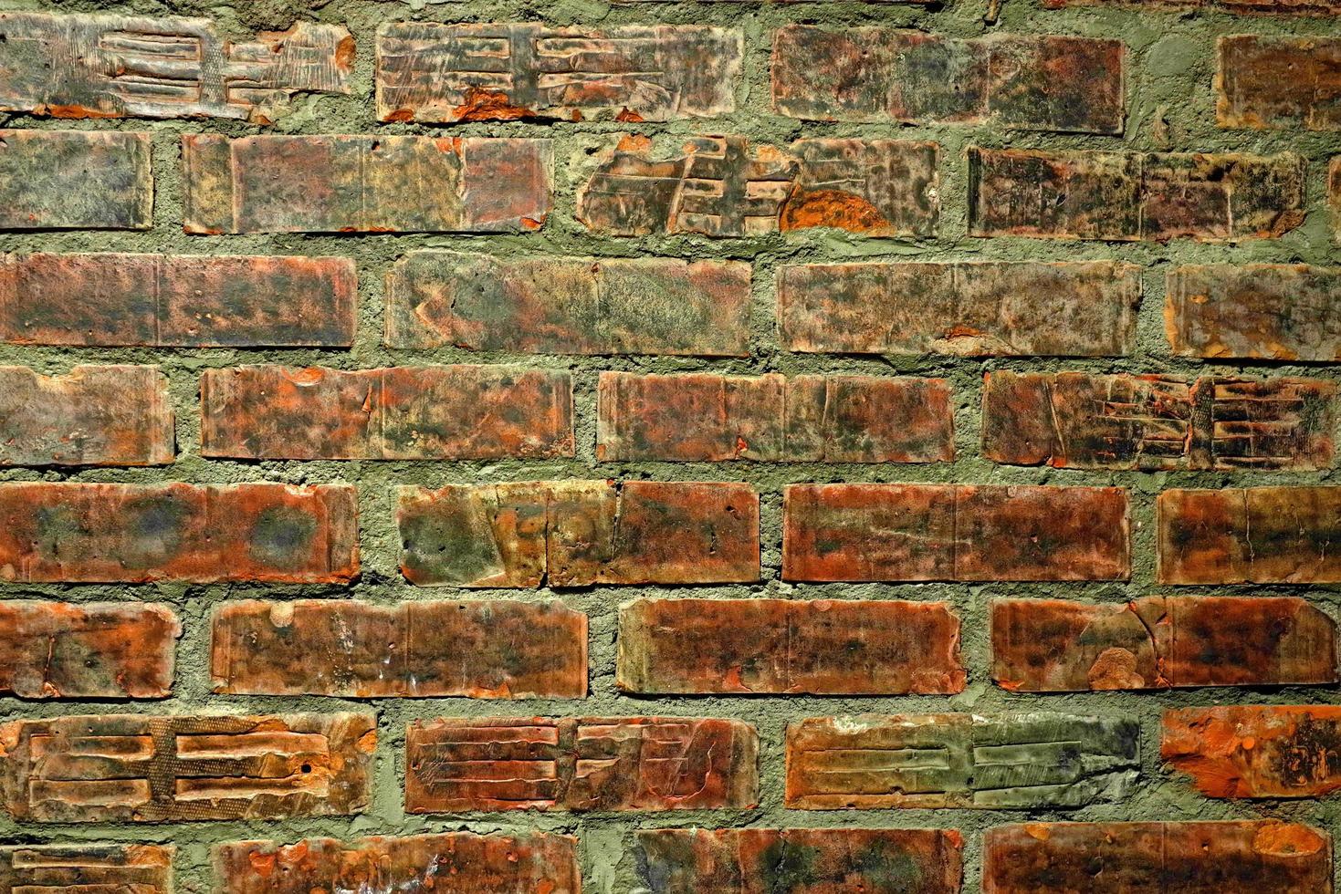 Fondo de textura de pared de ladrillo desgastado viejo verde rojo. foto