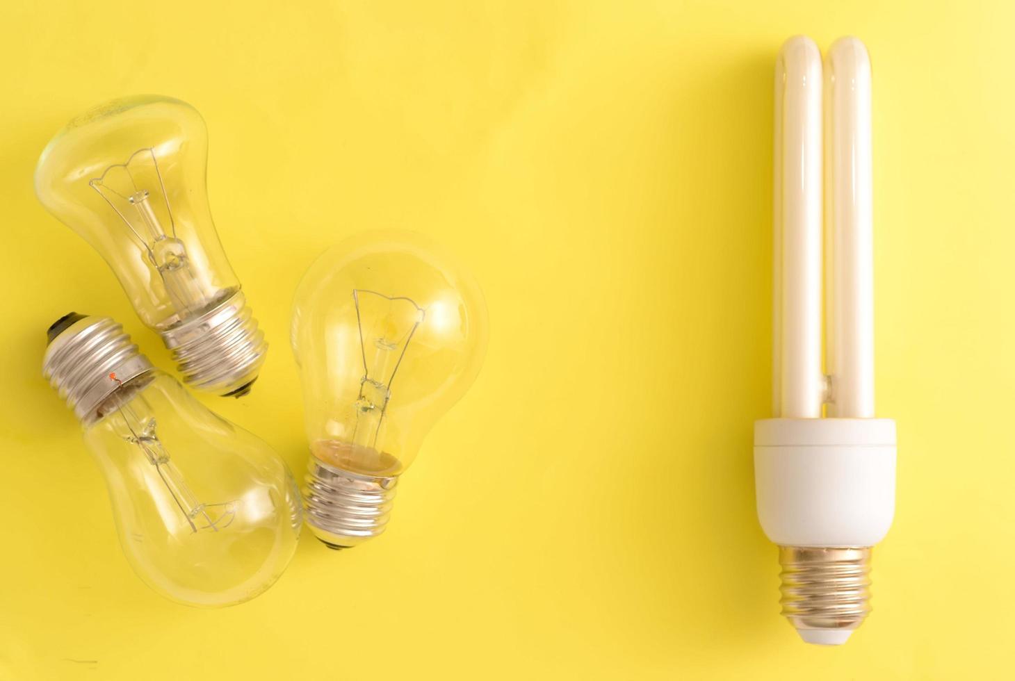 Energy-saving lamp vs. incandescent lamps. photo