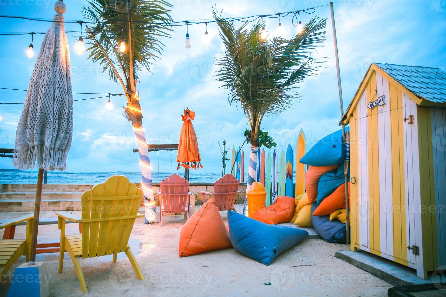 Beautiful view of beach at dusk with colorful chair set for relax photo