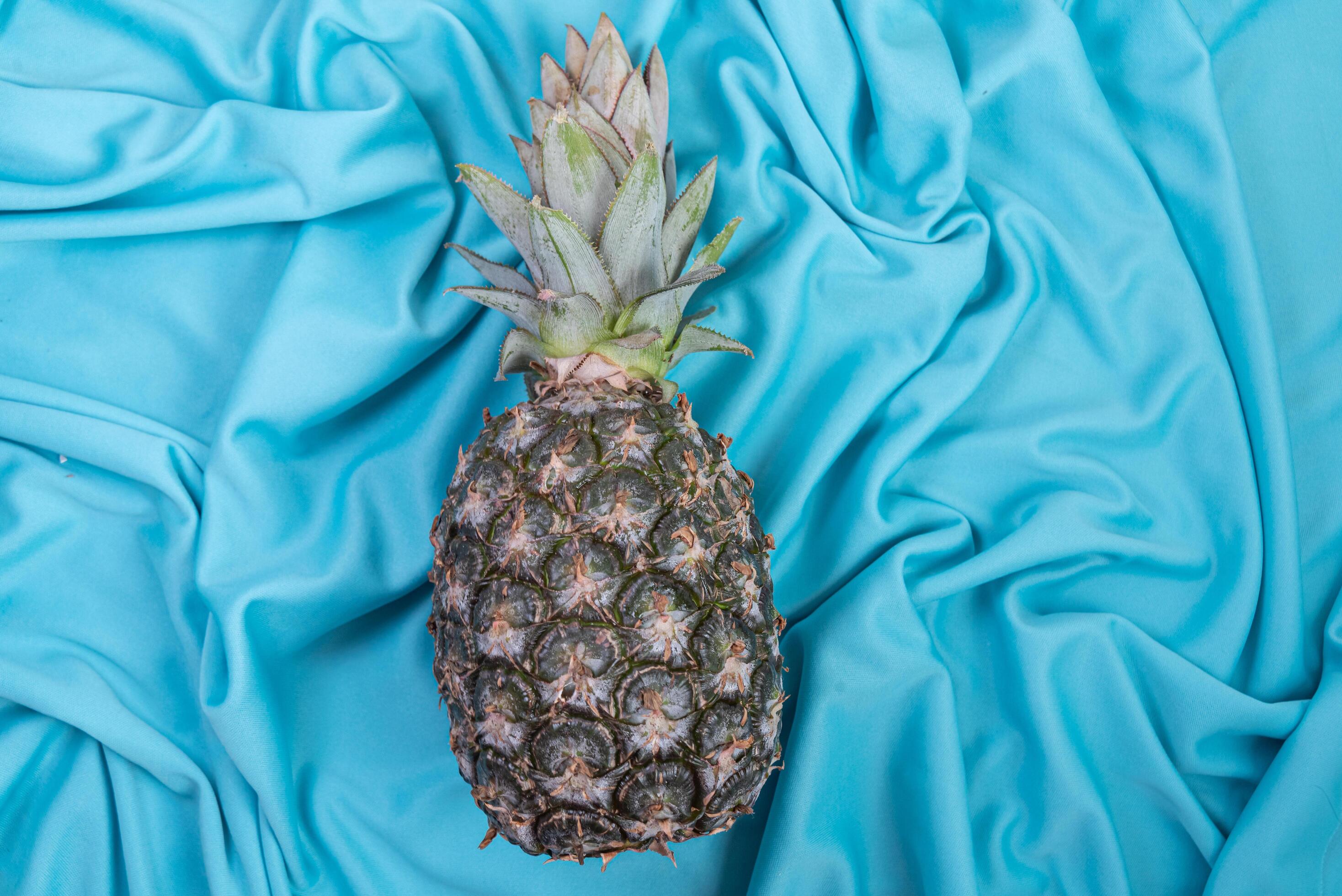 Pineapple on the blue background 6419971 Stock Photo at Vecteezy