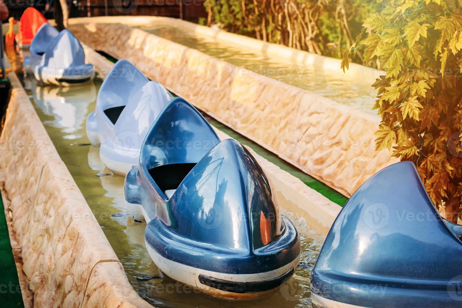 children's attraction with boats in amusement park photo