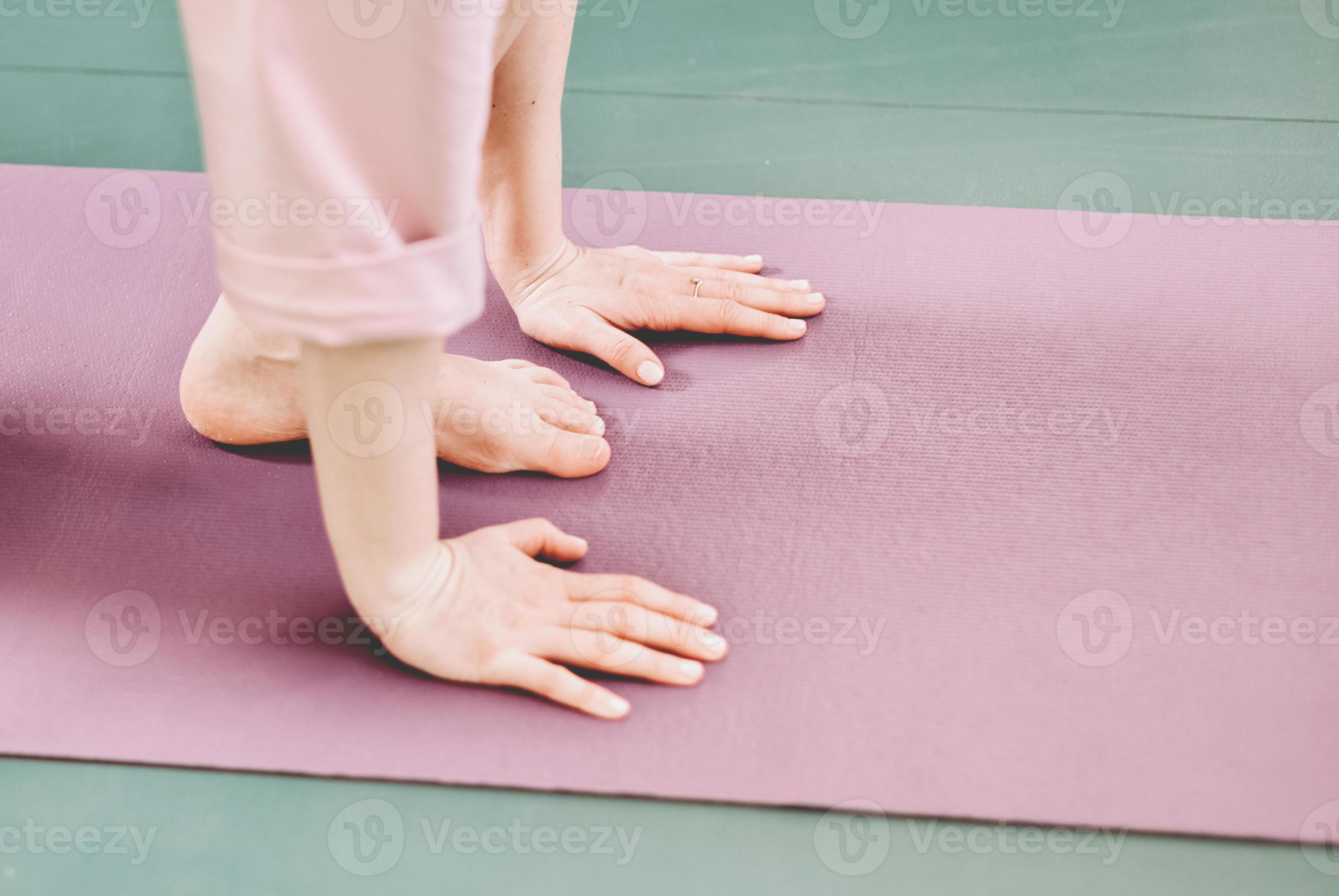hands and legs of a woman doing yoga on a yoga mat. sefl care rituals