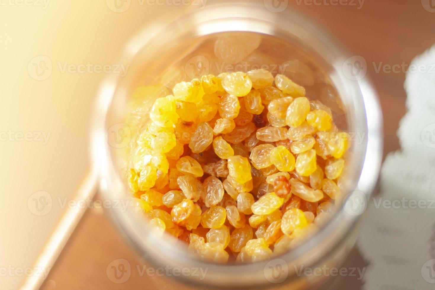 Close up Raisin in a glass jar top angle photo