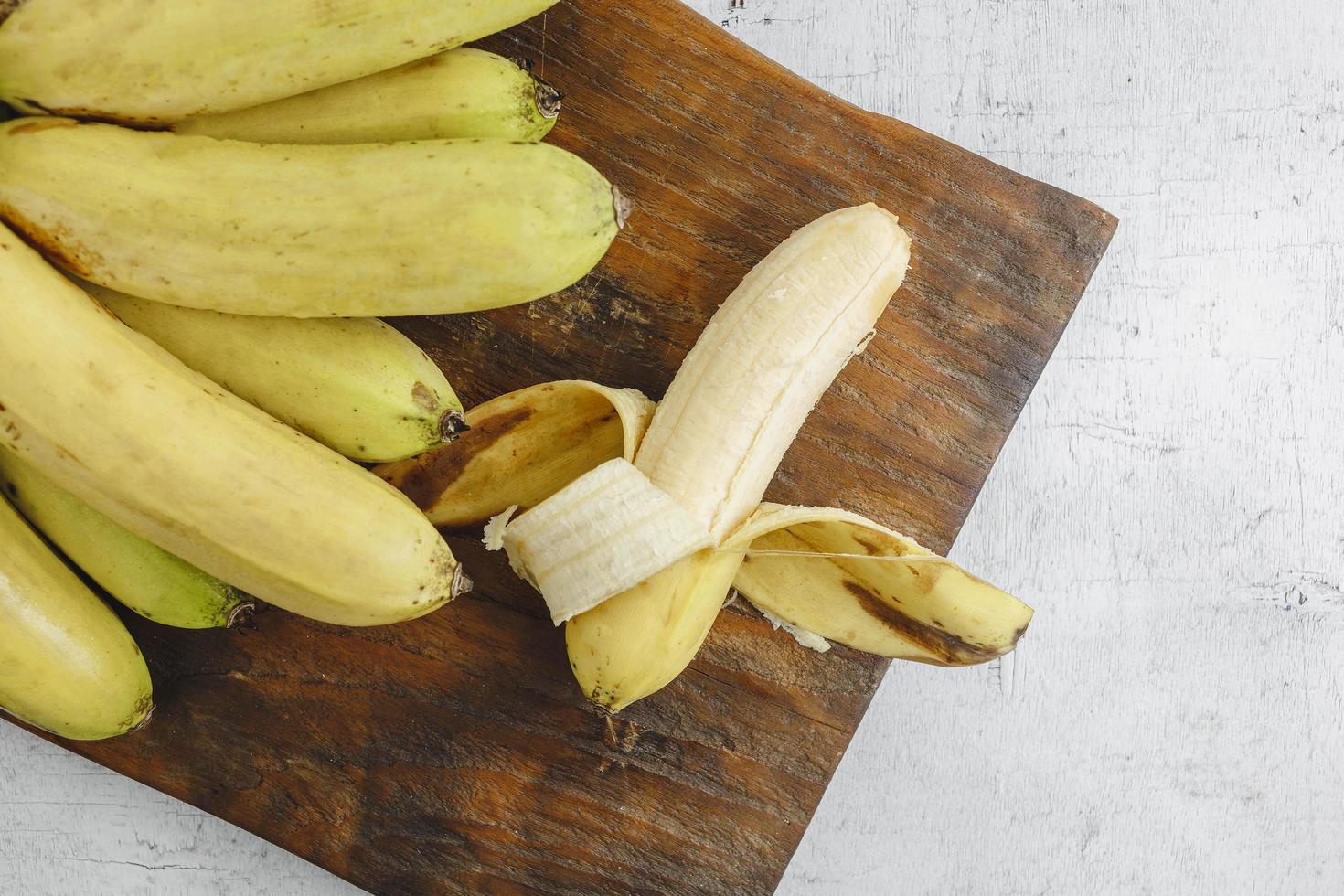 Open banana   on white wooden table photo