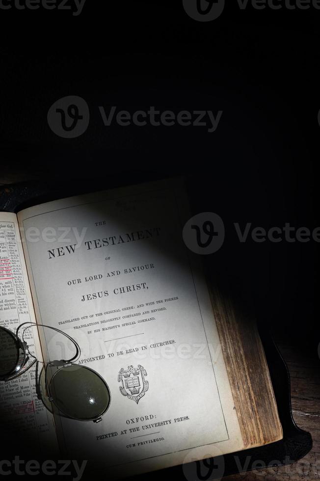An Old Open Holy Bible from 1882 on Wooden Table photo