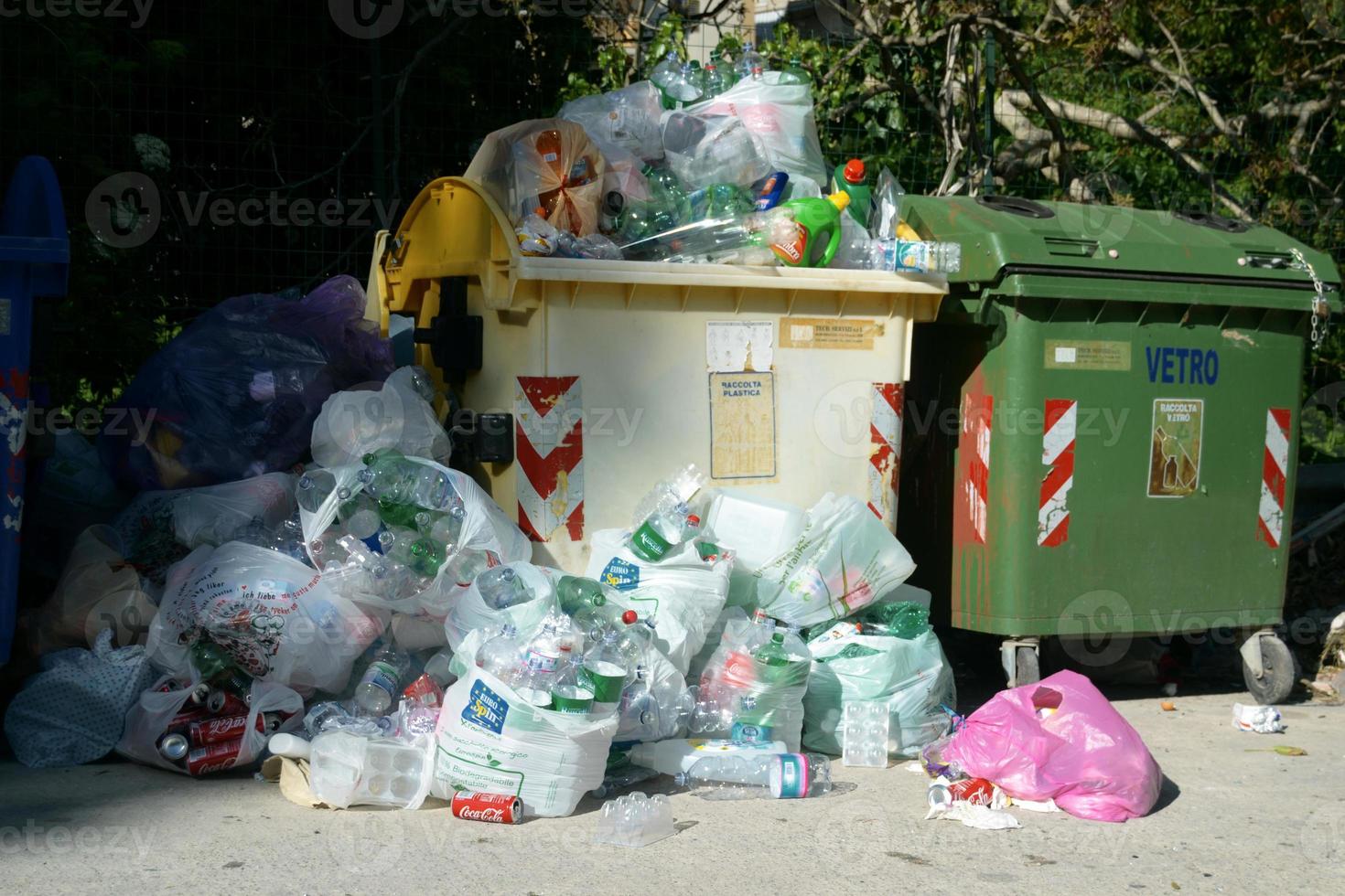 Municipal bins with plastic and aluminum waste overflowing with containers. Municipal waste overflows with containers. photo
