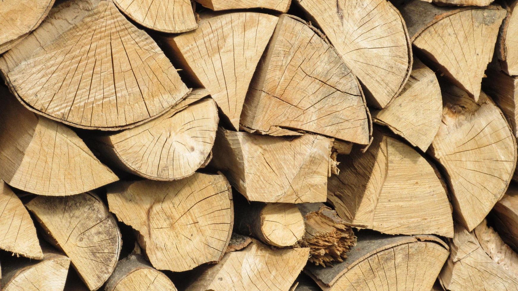 stack of firewood. Chopped wooden logs stacked in the woodpile photo