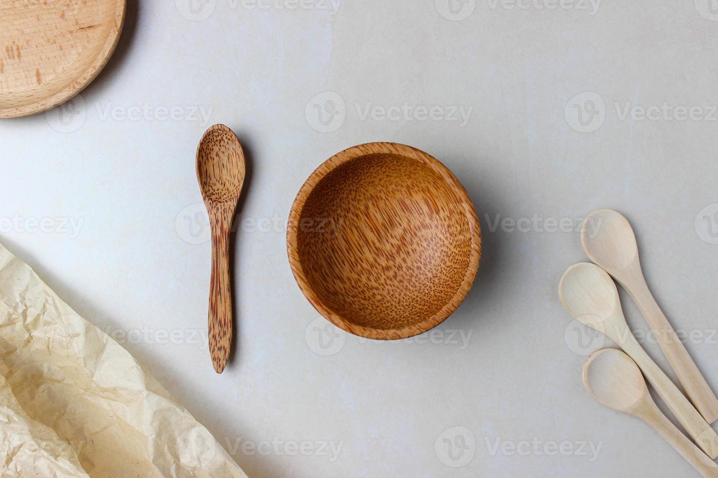 Wooden utensils on the kitchen table. Round wooden plates, a wooden spoon. The concept of serving, cooking, interior details. Top view photo