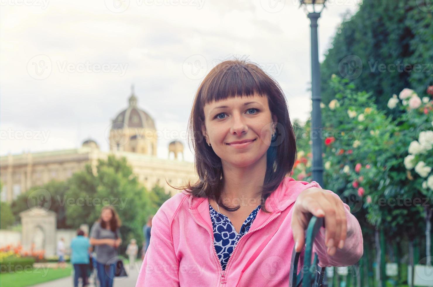 Close-up portrait of young beautiful caucasian girl looking at camera and smile in Volksgarten garden park photo