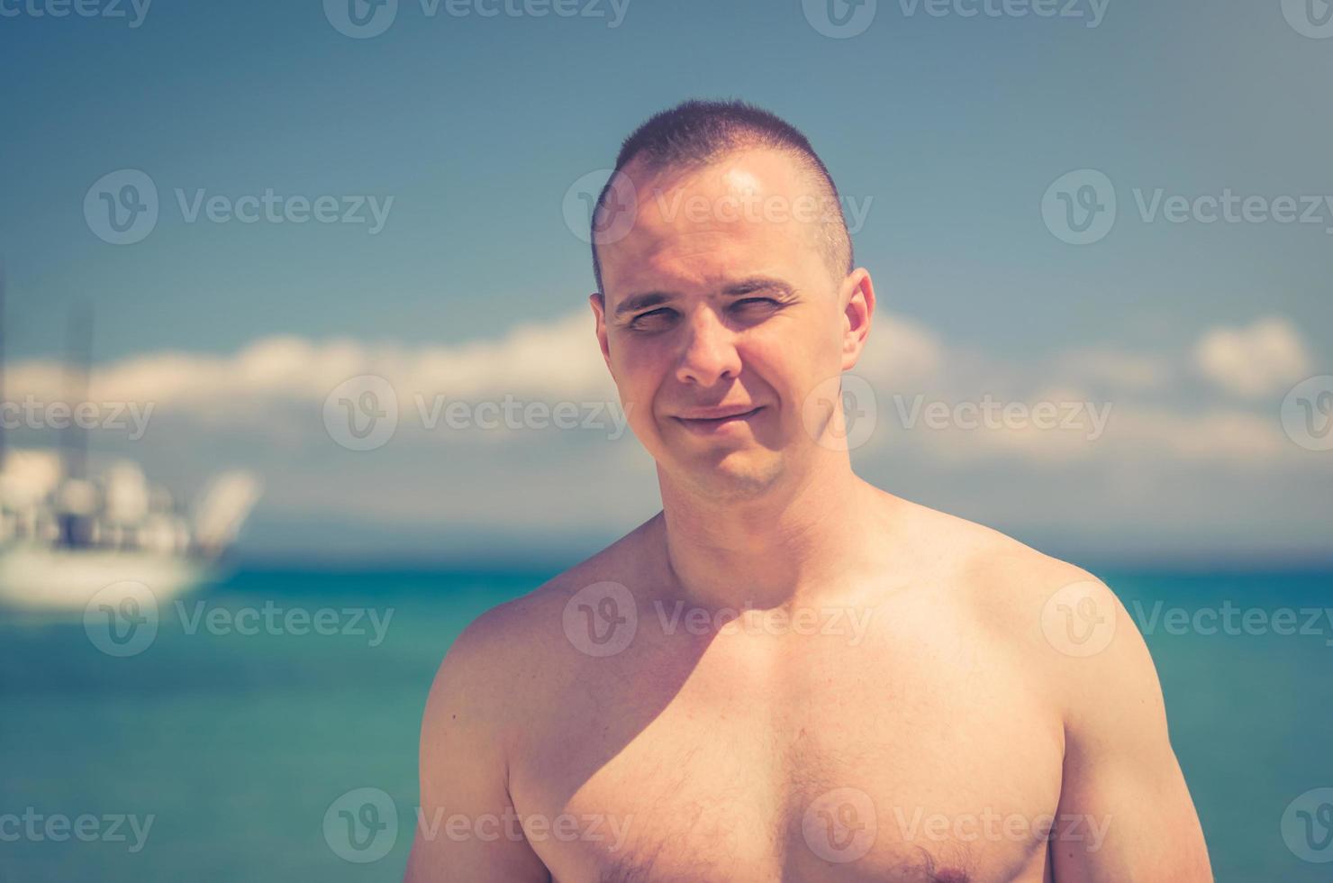 Close-up portrait of young muscular shirtless nake male bodybuilder man with athletic body photo