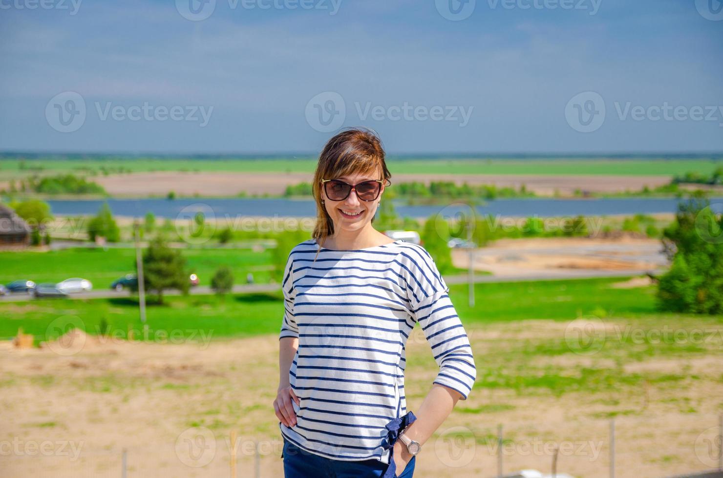 Young beautiful girl traveler with sunglasses stay, smile and posing in Kosava Kossovo village photo