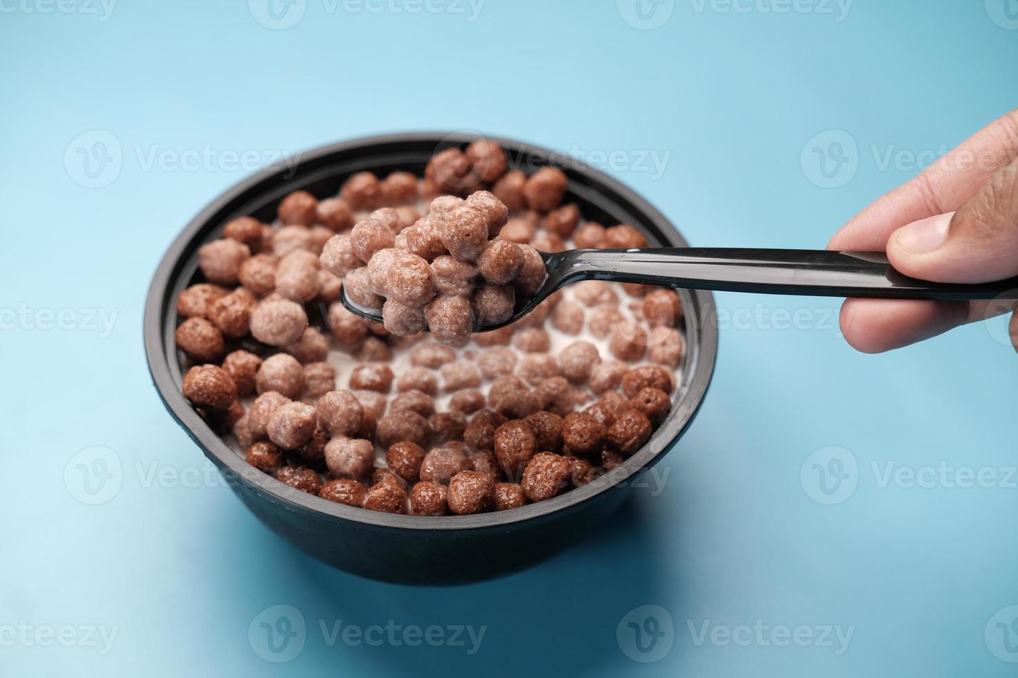 Top view of chocolate corn flakes in a bowl on pink photo