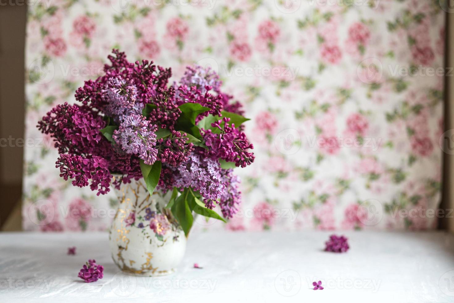 Bouquet of violet lilac in a vase. Still life with blooming branches of lilac in vases. photo