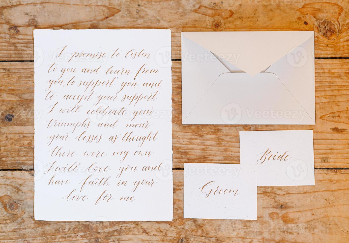 Wedding details flat lay on wooden background. Wedding invitation. Wedding bouquet. Mock up. Envelope. Copy space. photo