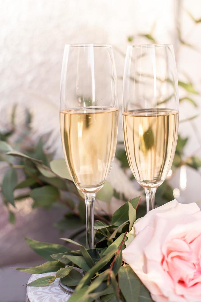 Composition with glasses of vine and flowers on grey concrete background. photo