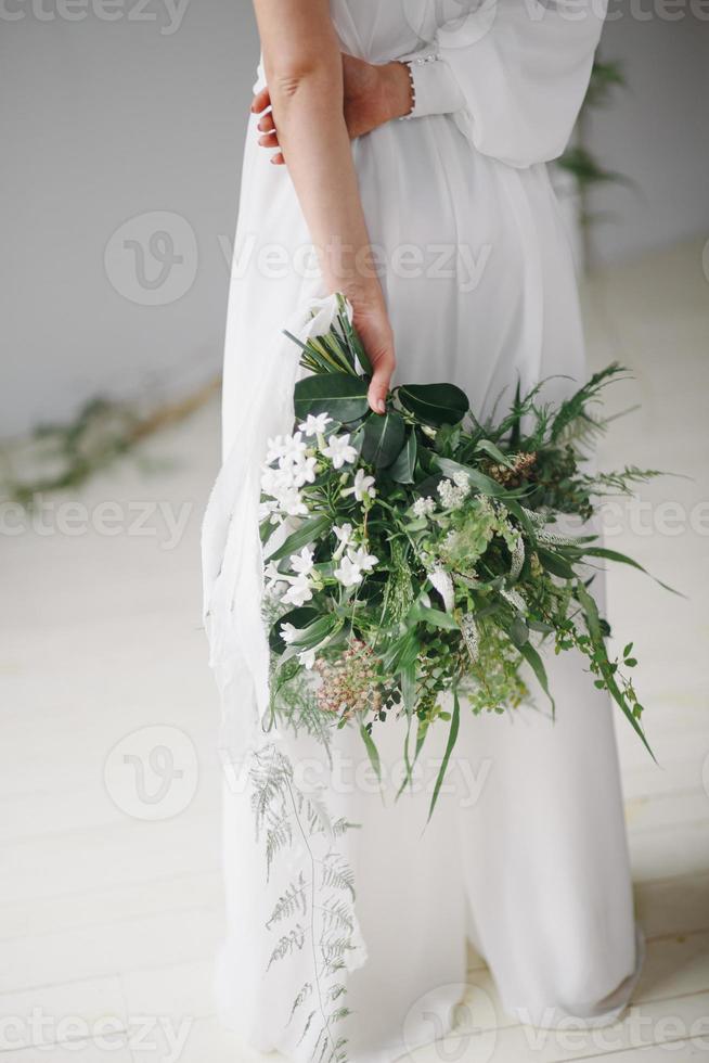 Wedding details flat lay. Wedding invitation and scroll paper. Bottle with fragrance. Ring box. Simple bouquet. photo