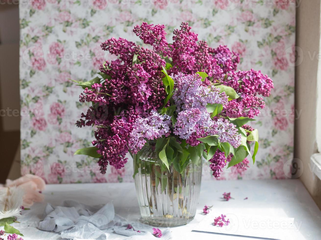 Bouquet of violet lilac in a vase. Still life with blooming branches of lilac in vases. photo