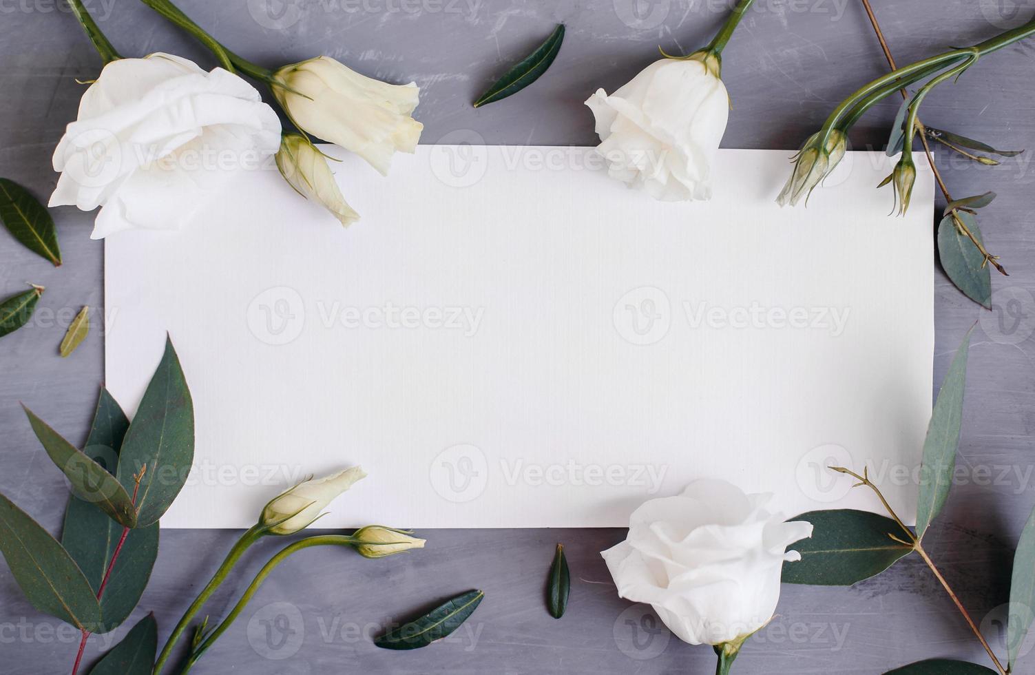 Blank paper copy space. Frame with flowers. Silk ribbon. Gray background. Simple bouquet. Greeting card. photo