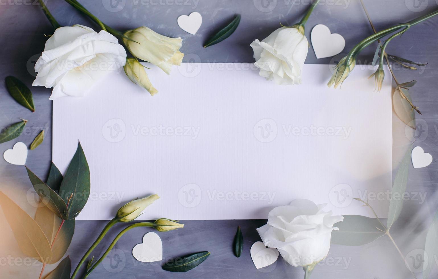 Blank paper copy space. Frame with flowers. Silk ribbon. Gray background. Simple bouquet. Greeting card. photo