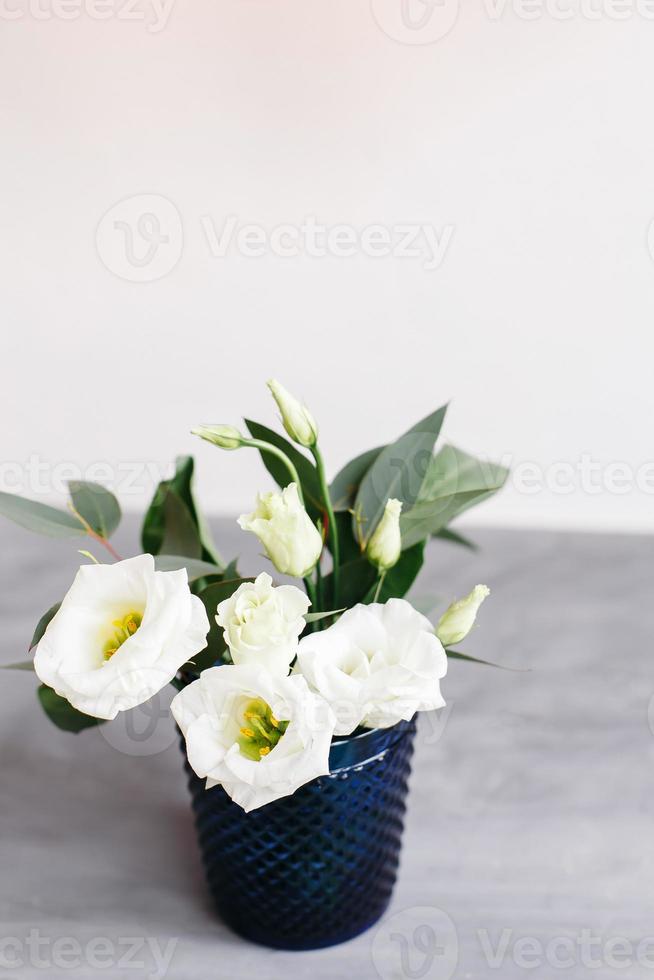 White flowers in classic blue glass. Lisianthus. Eustoma photo